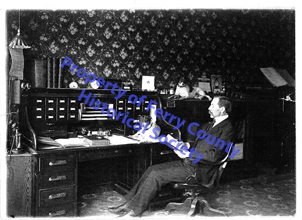 Barness seated in the Curlew Mining Company office in Republic